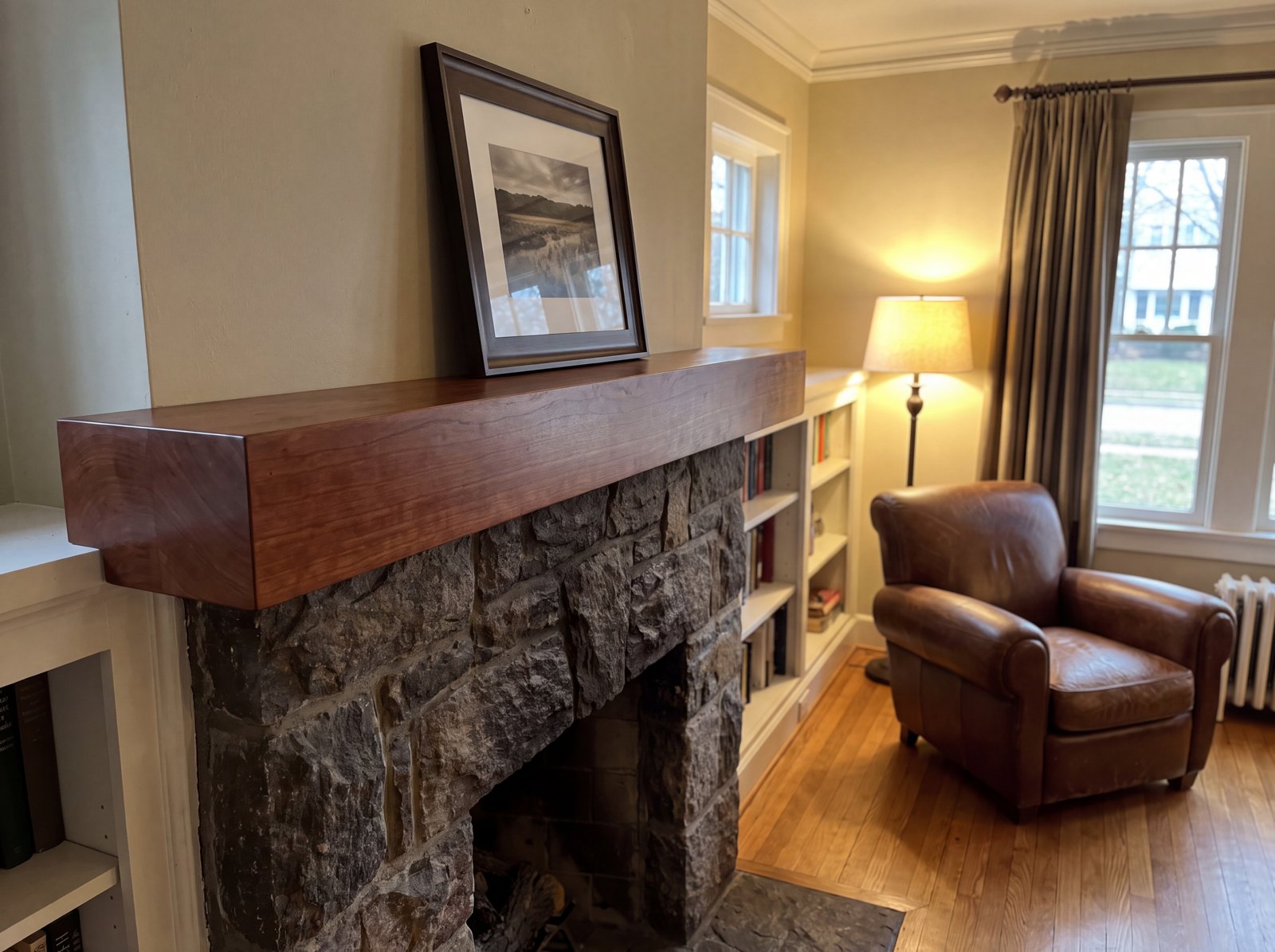 Solid Brazilian cherry mantel with a rich stained finish over a stone surround
