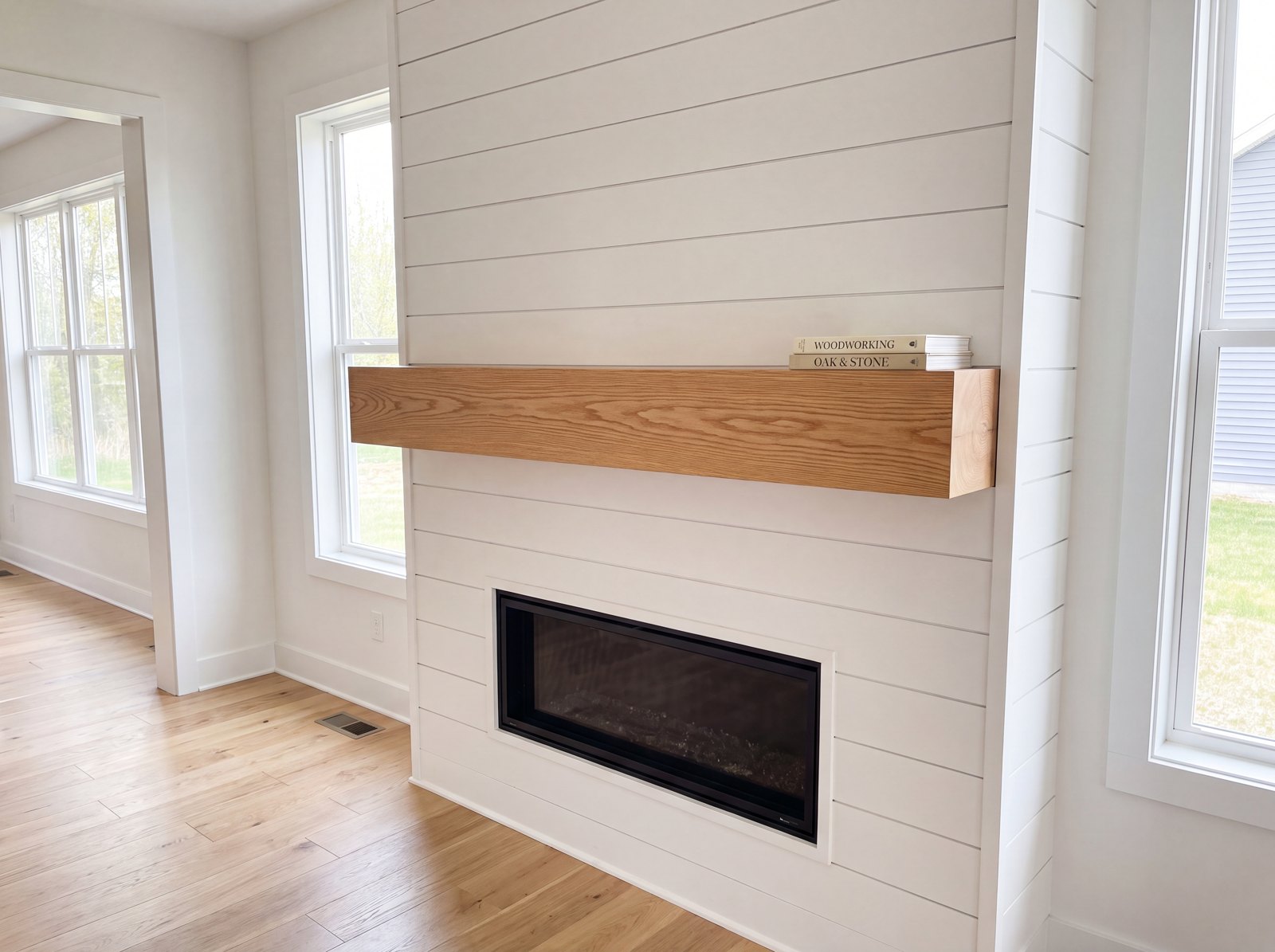 Solid red oak mantel with a natural satin finish on a shiplap fireplace