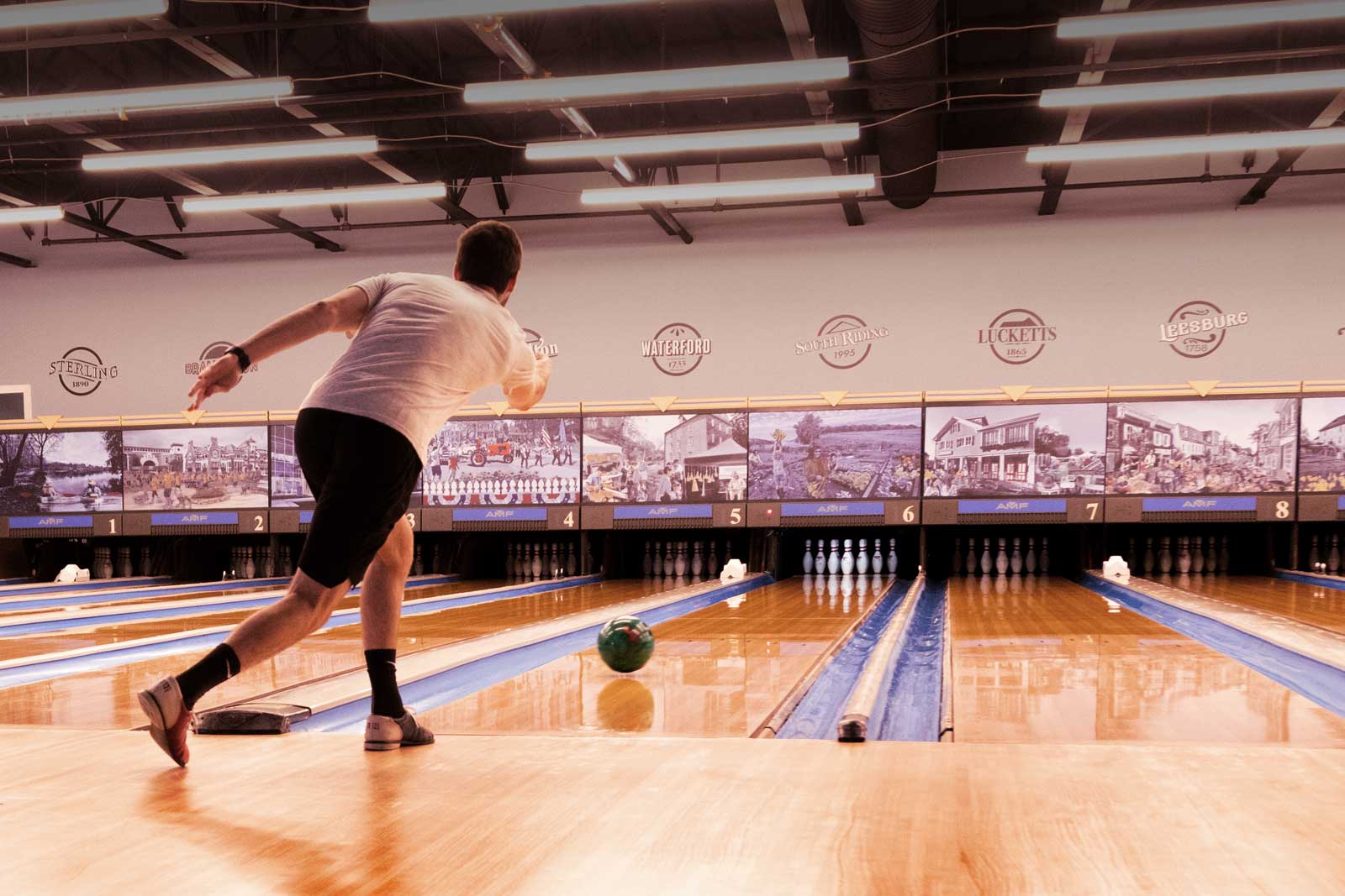 A bowler mid-throw on the finished lanes