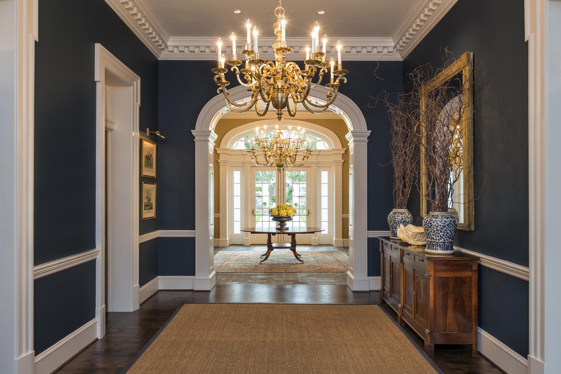 Foyer with arched openings and dentil cornice